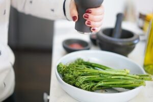 Bowl of broccolini, a food that relaxes muscles. 