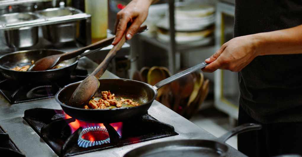 Chef using nonstick cookware on high heat. 