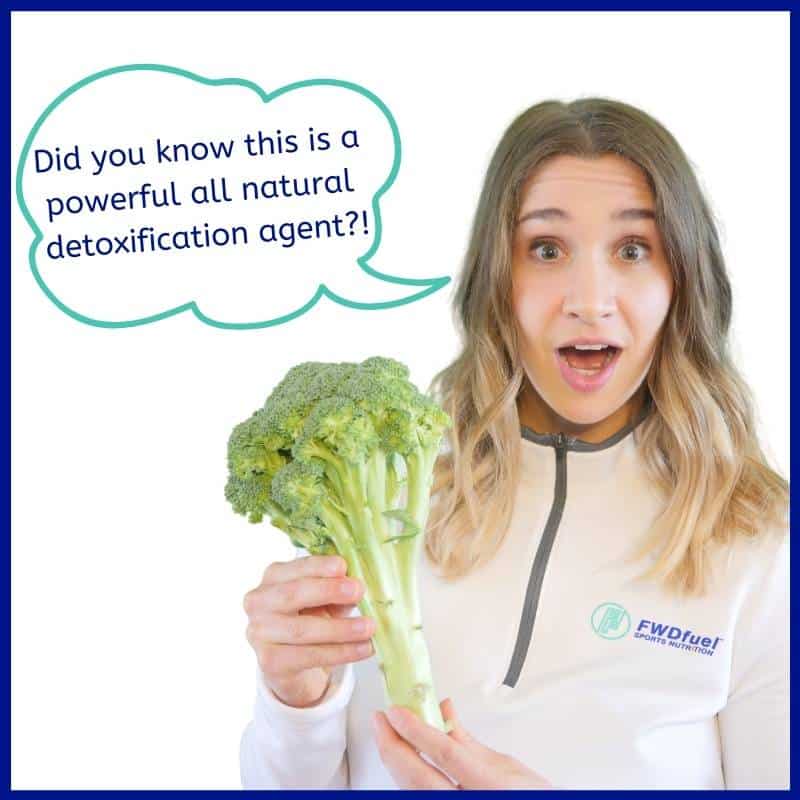 Dietitian Abby Grimm holding broccoli as an example of a vegetable that helps detoxification 