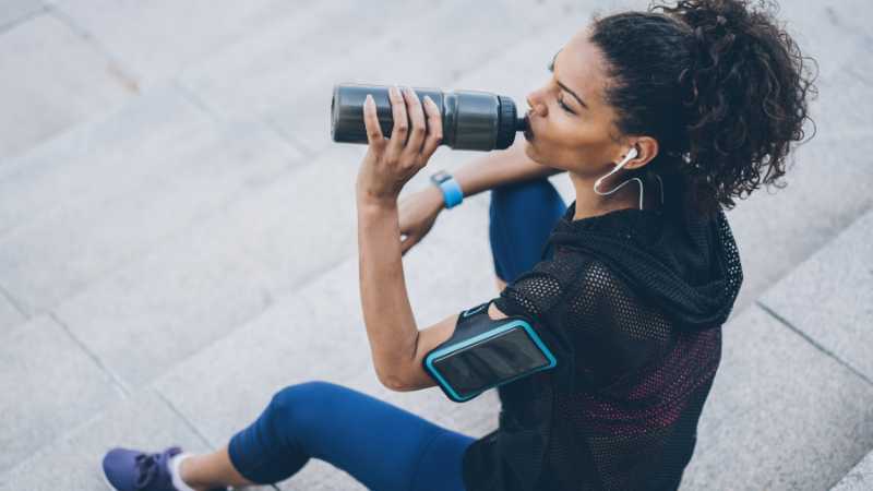 Women hydrating post exericse wondering how much salt to add to water for hydration.