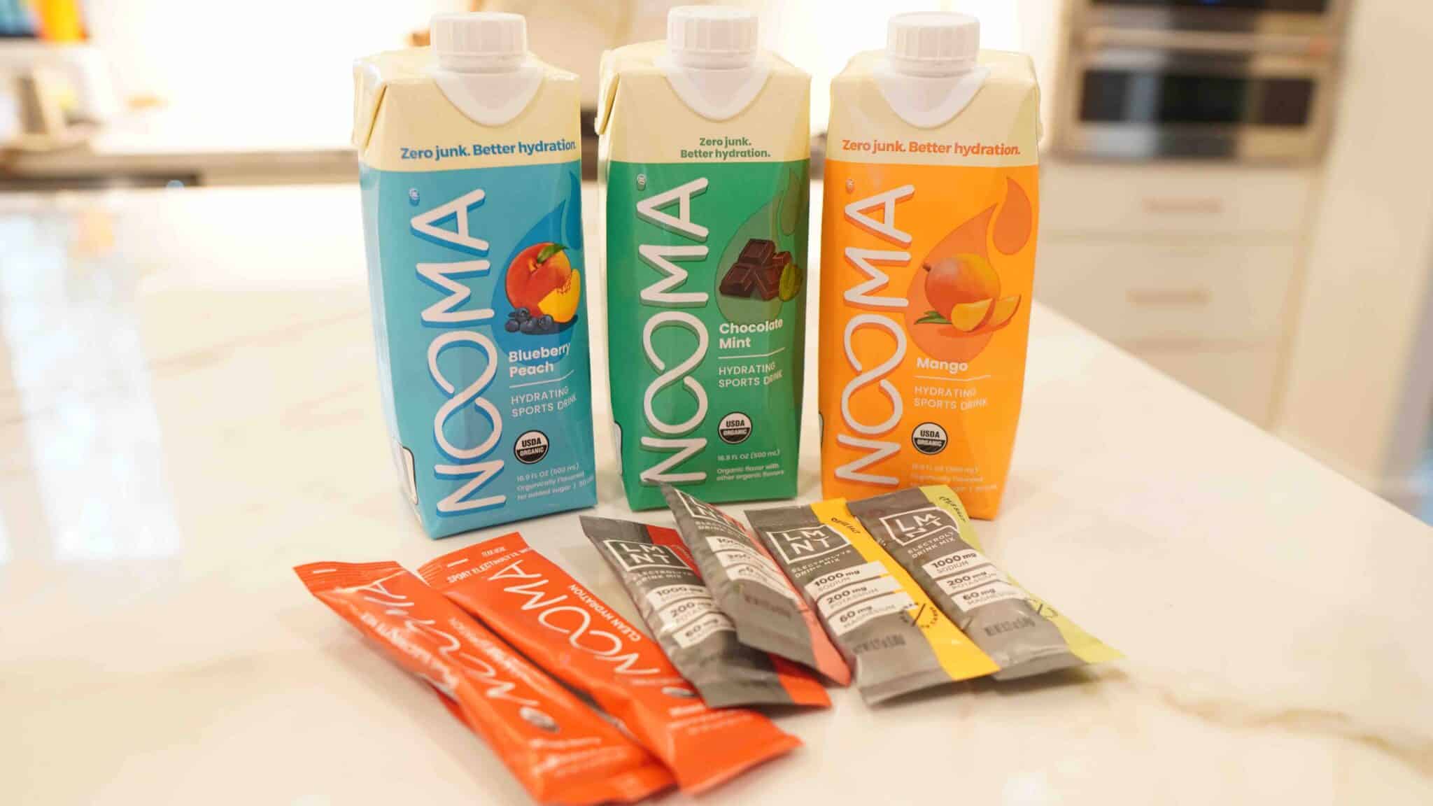 Cans of NOOMA Organic Electrolyte Sports Drink and LMNT drink packets to help improve hydration when recovering from mold illness.