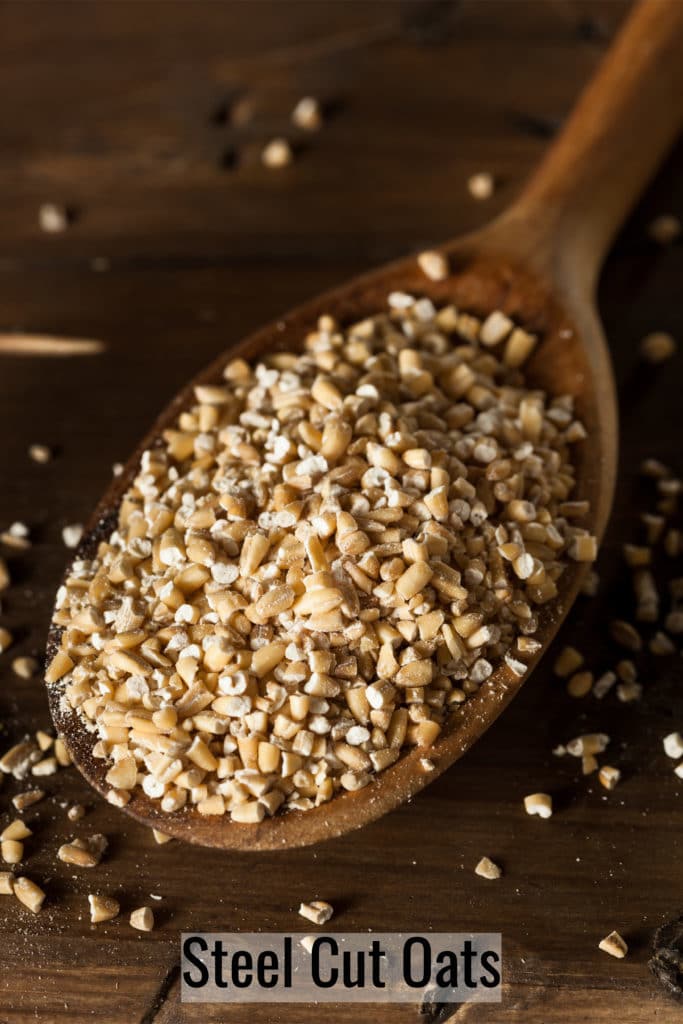 uncooked steel cut oats on a sppon to be used to make overnight steel cut oats recipe