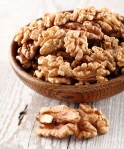 Bowl of walnuts which are full of vitamins and minerals making them one of the best nuts for athletes. 